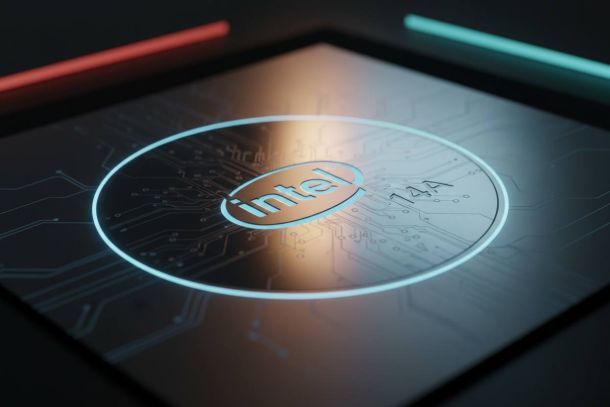 The Intel logo glows within a circular circuit design on a dark, futuristic surface with red and teal accents.